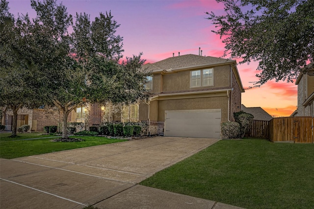 view of front of home with a garage and a lawn