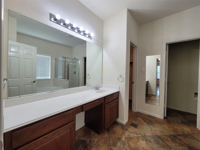 bathroom featuring vanity and independent shower and bath