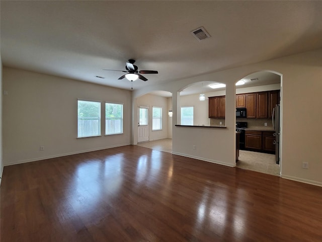 unfurnished living room featuring ceiling fan and light hardwood / wood-style floors