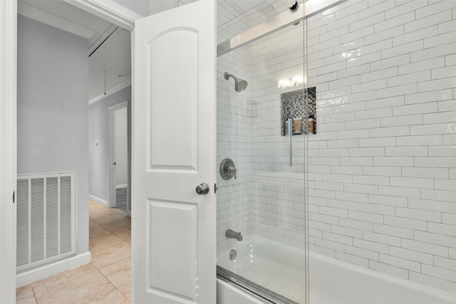 bathroom featuring tile patterned flooring and shower / bath combination with glass door