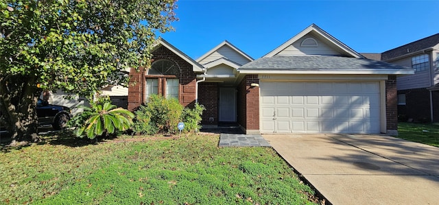 view of front of property with a garage and a front lawn