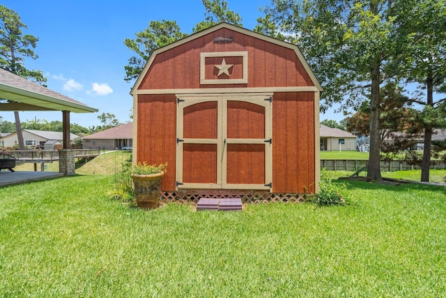 view of outbuilding featuring a lawn