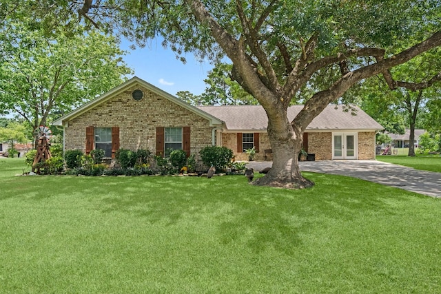 single story home with french doors and a front yard