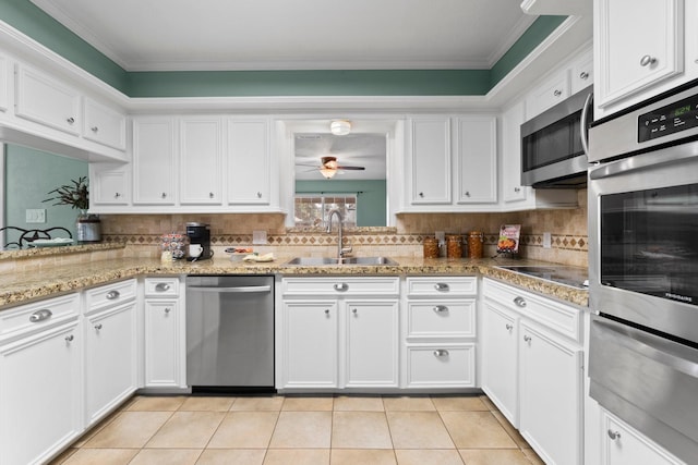 kitchen featuring white cabinets, ceiling fan, sink, and stainless steel appliances