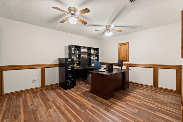 office space featuring ceiling fan, dark hardwood / wood-style flooring, and a textured ceiling