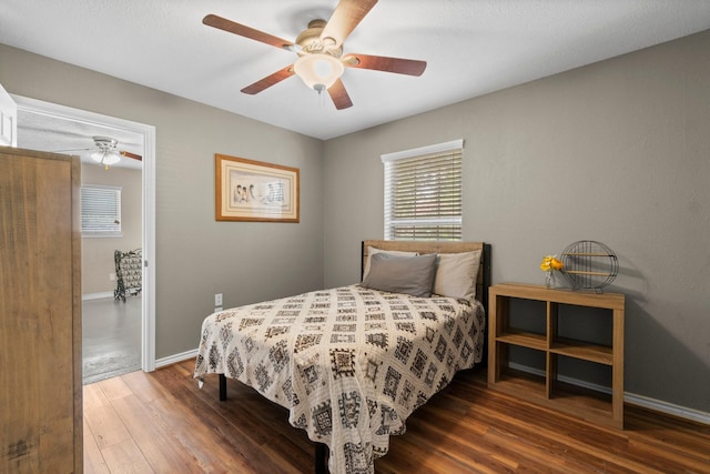 bedroom featuring ceiling fan and dark hardwood / wood-style floors