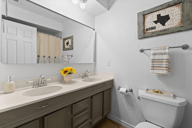 bathroom featuring vanity and toilet