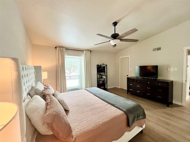 bedroom featuring vaulted ceiling, ceiling fan, and hardwood / wood-style flooring