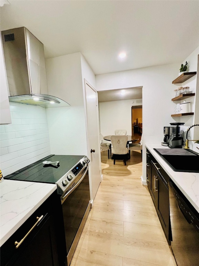 kitchen with sink, dishwasher, wall chimney exhaust hood, stainless steel electric range, and light stone countertops