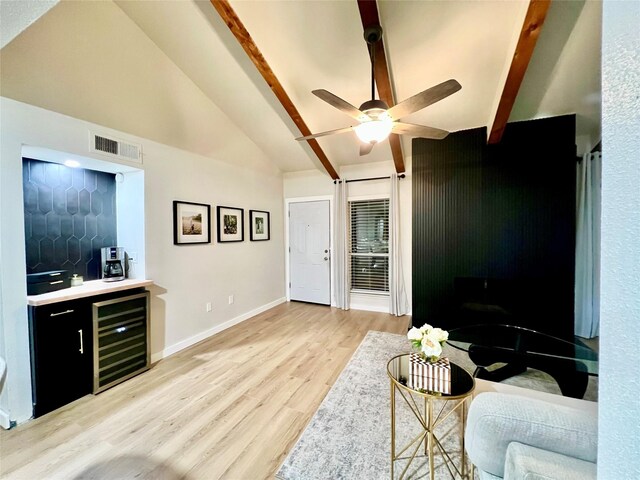 living room with beverage cooler, lofted ceiling with beams, ceiling fan, and light hardwood / wood-style flooring