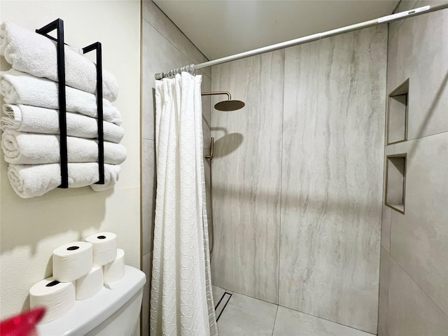 bathroom featuring curtained shower and toilet