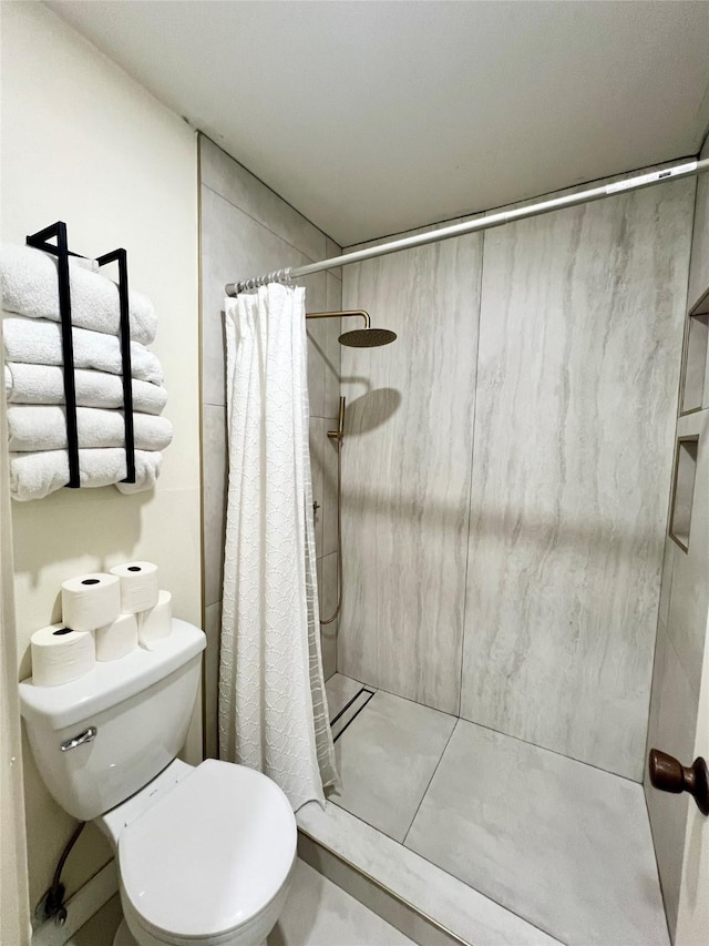 full bathroom with toilet and a stall shower