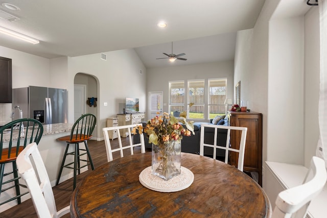 dining area featuring ceiling fan, dark hardwood / wood-style flooring, and vaulted ceiling