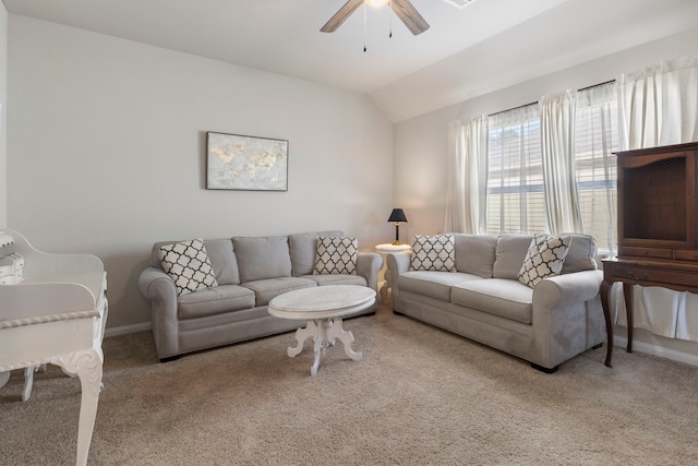 carpeted living room with ceiling fan and lofted ceiling