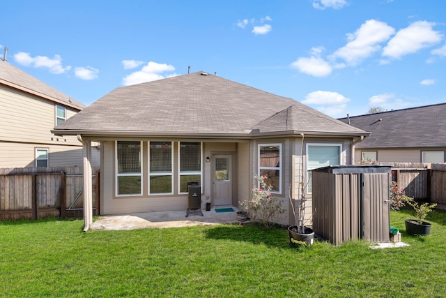 rear view of house featuring a lawn