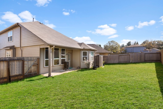 rear view of house with a yard