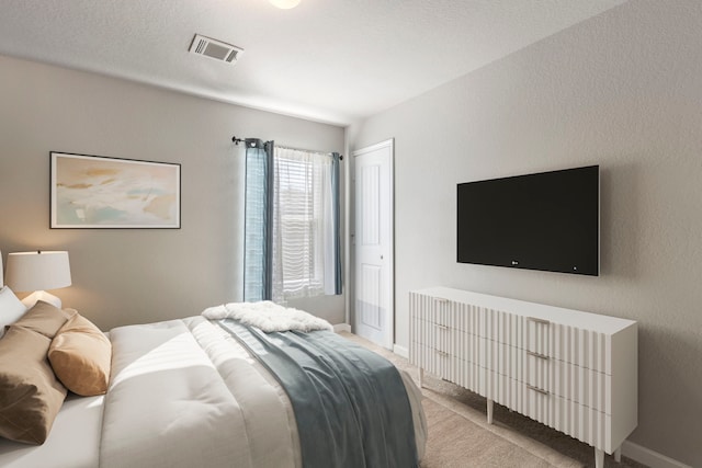 bedroom featuring light colored carpet