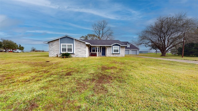 ranch-style house featuring a garage and a front lawn