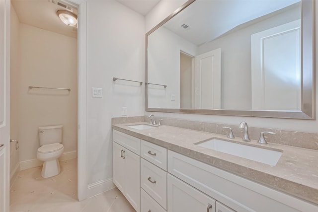 bathroom with vanity, tile patterned floors, and toilet