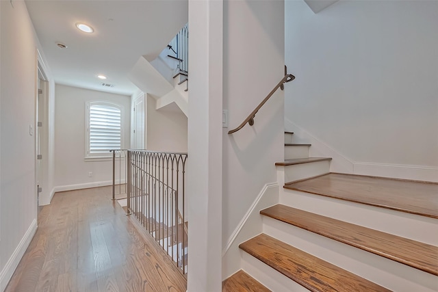 staircase with wood-type flooring