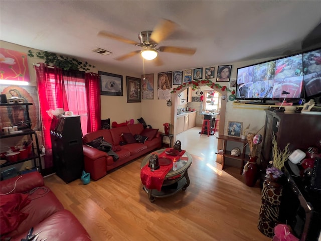 living room with wood-type flooring and ceiling fan