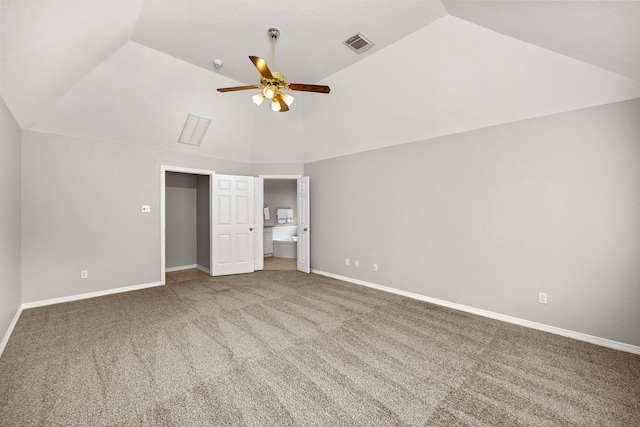 unfurnished bedroom featuring carpet, ceiling fan, and vaulted ceiling