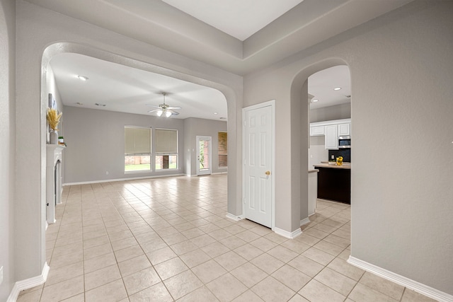 interior space featuring ceiling fan and light tile patterned floors