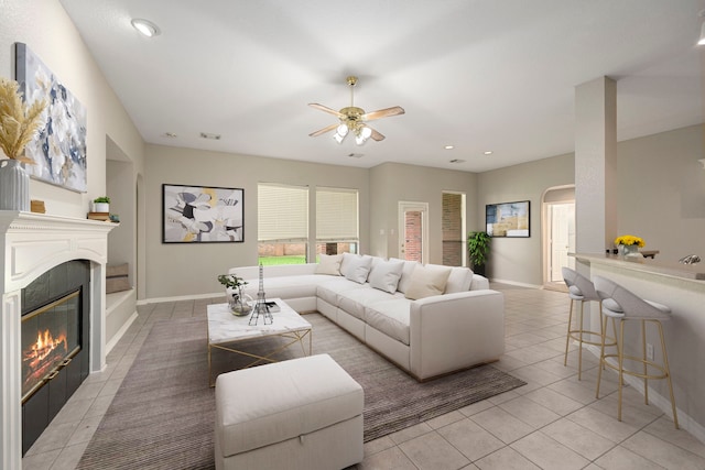 living room featuring ceiling fan and light tile patterned flooring