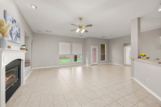 unfurnished living room featuring light tile patterned floors and ceiling fan