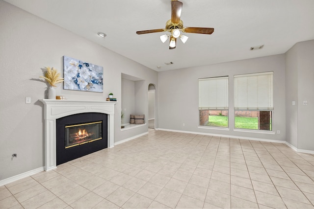 unfurnished living room featuring light tile patterned floors and ceiling fan