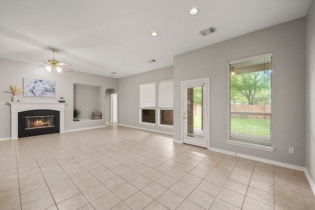 unfurnished living room with ceiling fan and light tile patterned flooring