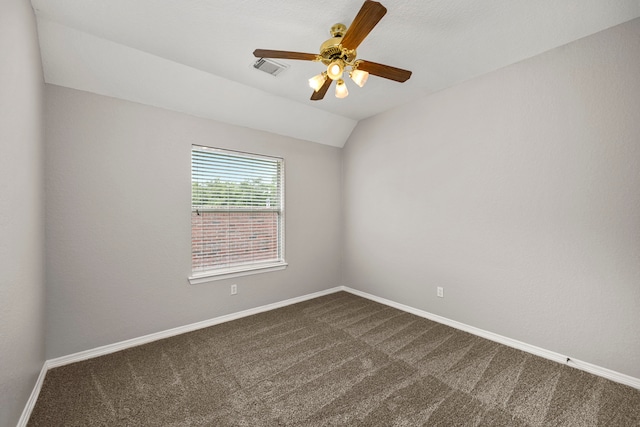 carpeted empty room featuring ceiling fan and vaulted ceiling