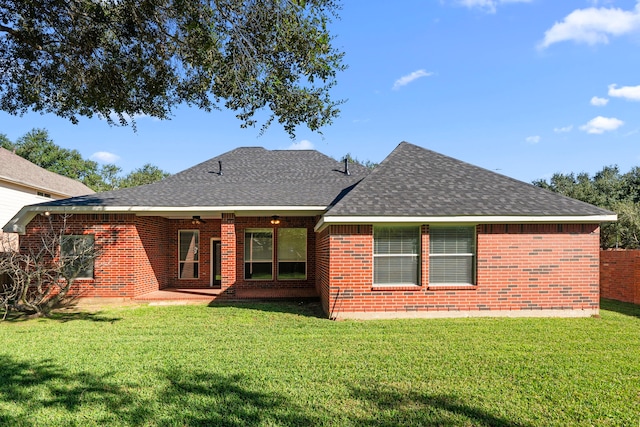 rear view of house with a yard and a patio