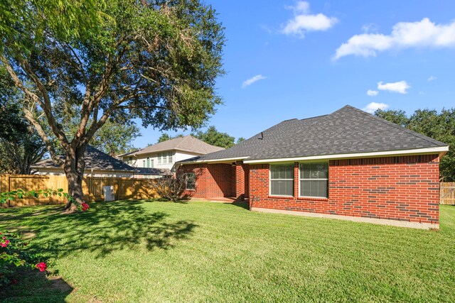 rear view of house with a yard