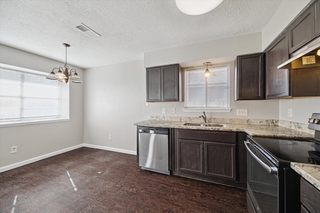 kitchen featuring hanging light fixtures, sink, appliances with stainless steel finishes, dark brown cabinetry, and a chandelier