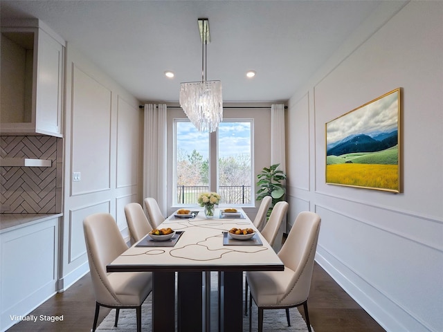 dining room featuring dark hardwood / wood-style floors and an inviting chandelier