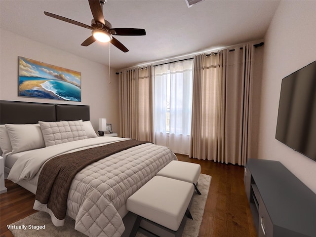 bedroom with dark hardwood / wood-style floors and ceiling fan