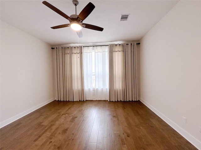 spare room with hardwood / wood-style floors and ceiling fan