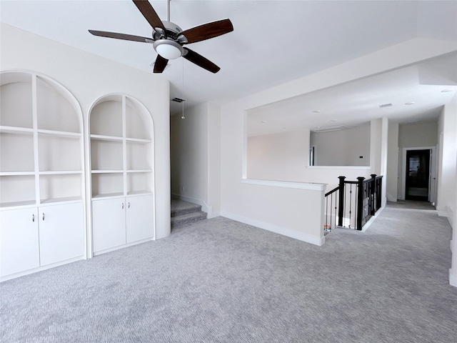 unfurnished room featuring light colored carpet and ceiling fan