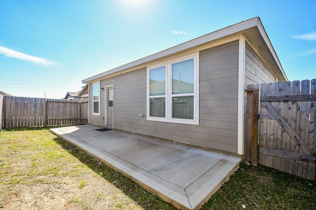 back of property featuring a yard and a patio area