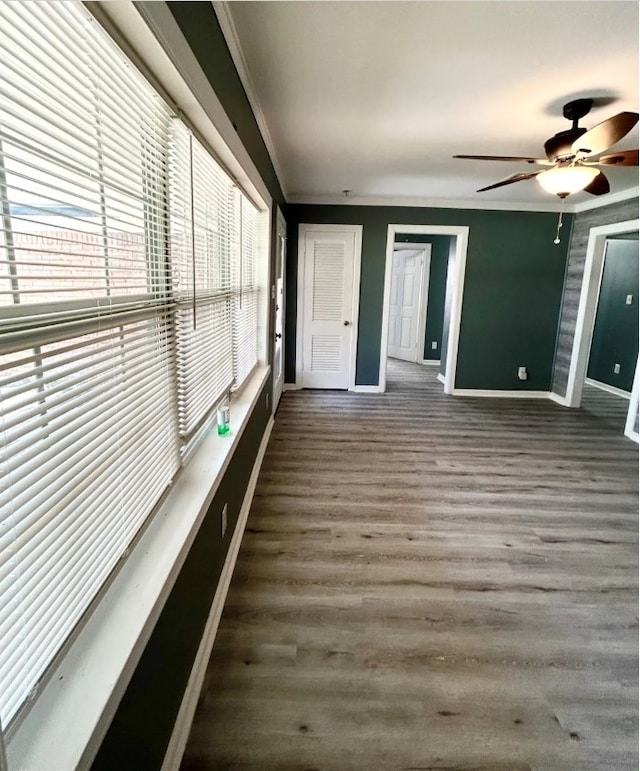 unfurnished sunroom with ceiling fan