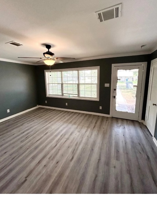 unfurnished living room with wood-type flooring, ceiling fan, and crown molding