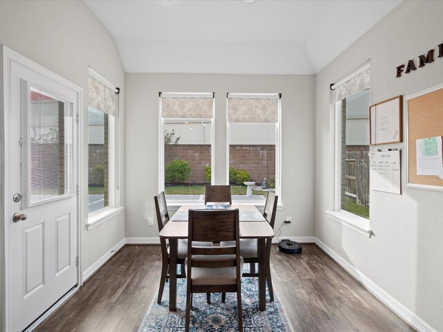 dining room featuring dark hardwood / wood-style floors and lofted ceiling