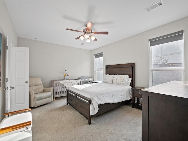 bedroom featuring ceiling fan and light colored carpet