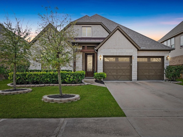 view of front of house with a lawn and a garage