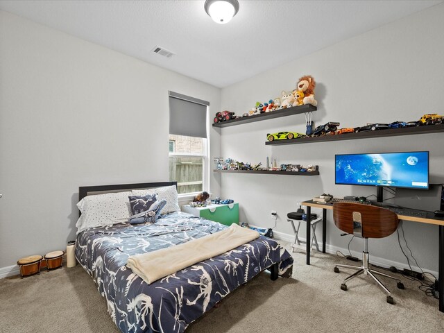 bedroom featuring light carpet