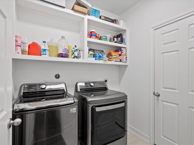 laundry room with washing machine and clothes dryer