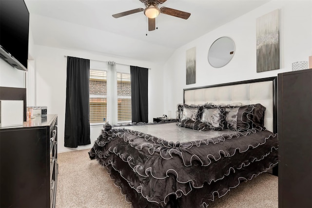 bedroom featuring ceiling fan, light carpet, and vaulted ceiling