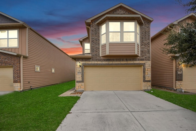 view of front of property with a lawn and a garage