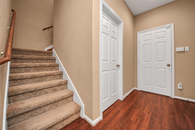 stairs featuring wood-type flooring